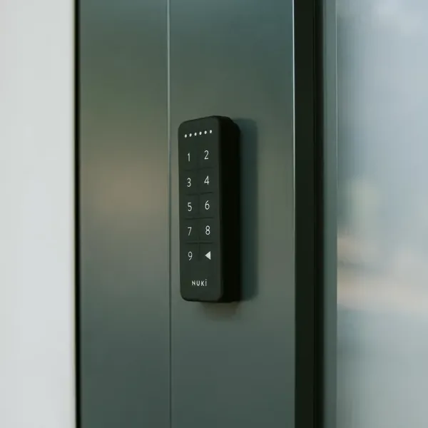 Tastierino Nuki Keypad nero montato su una porta d'ingresso in vetro